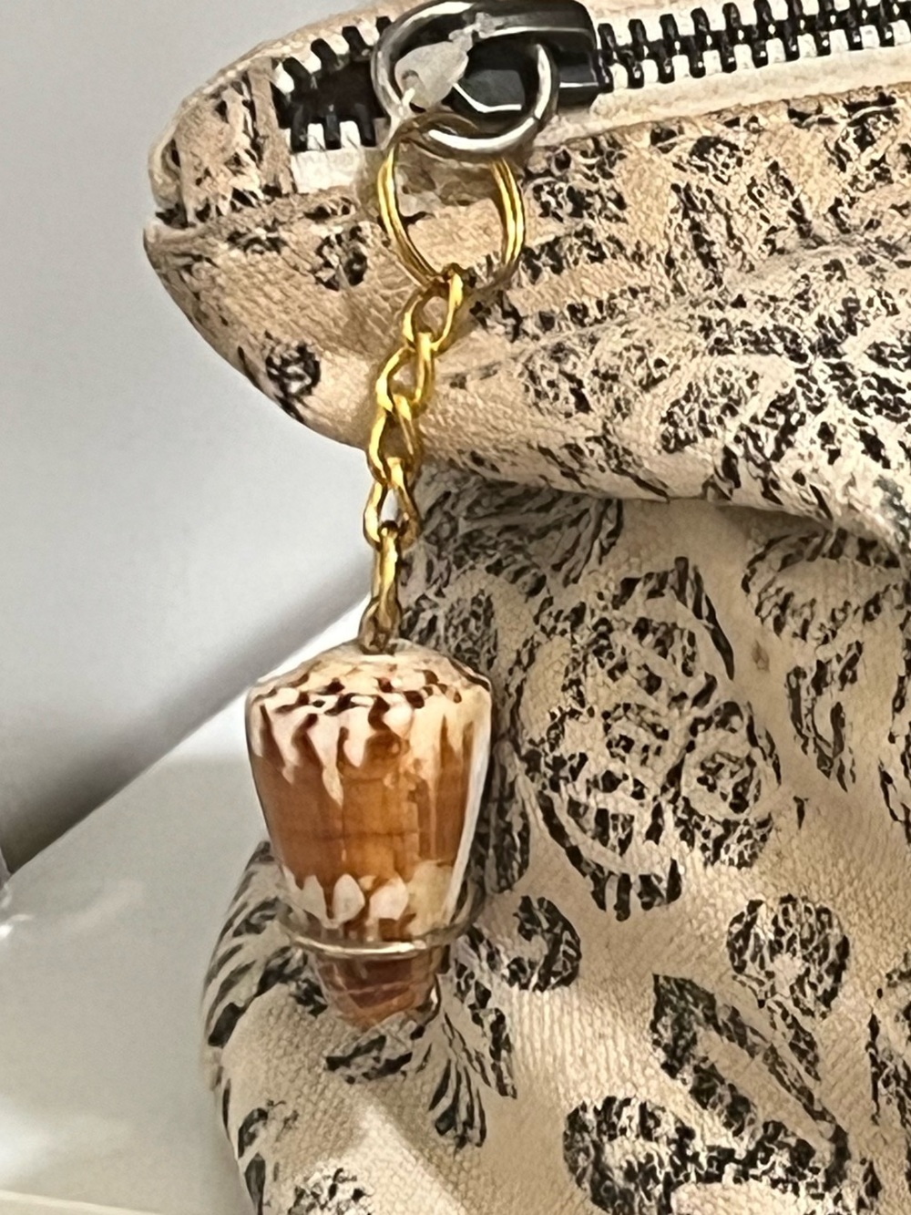 Beige & Black Floral Zip Pouch with Gold Chain Tassel Charm